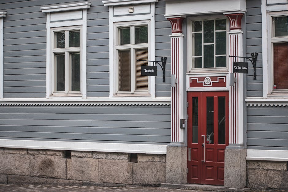 Vintage building facade with red door in Tampere, Finland. Classic Nordic architecture.