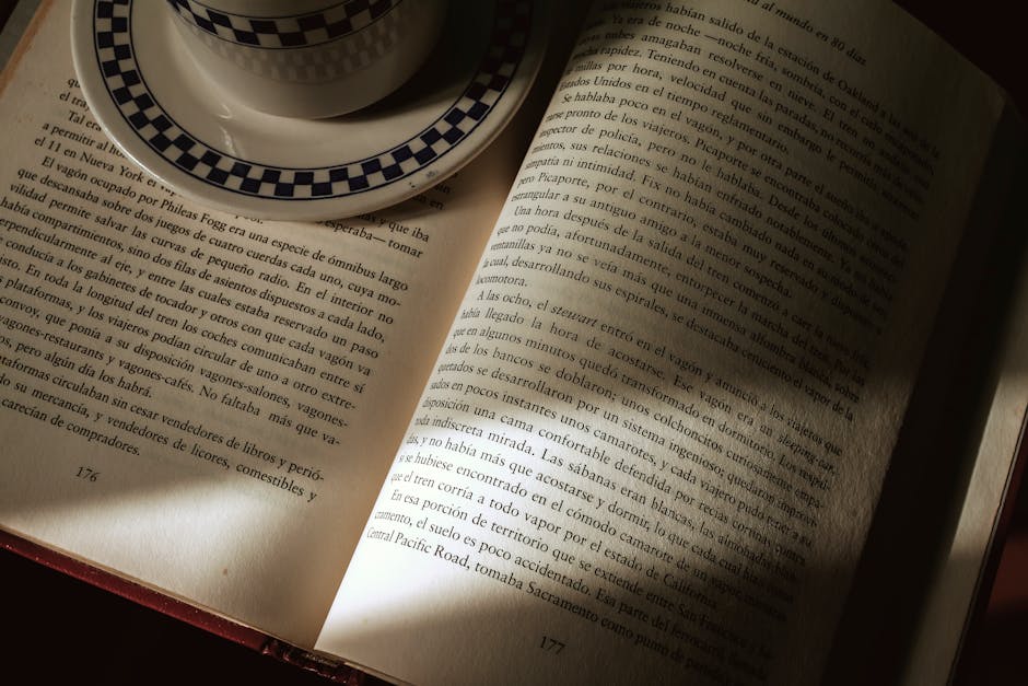 An open book with a coffee cup, capturing a serene reading atmosphere indoors.